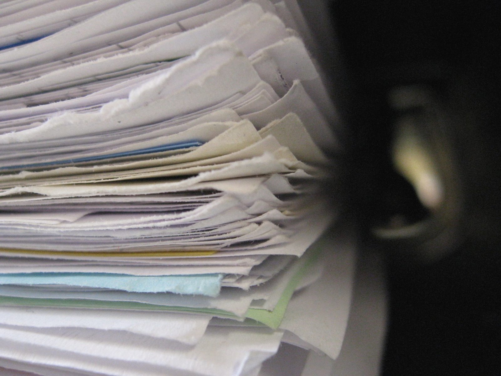 A thick stack of papers and folders seen edge-on